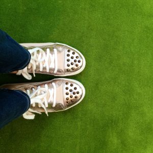 The view from above of some shiny gold sneakers." title="The view from above of some shiny gold sneakers.