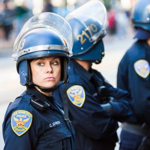 A group of police officers wearing helmets and face shields.