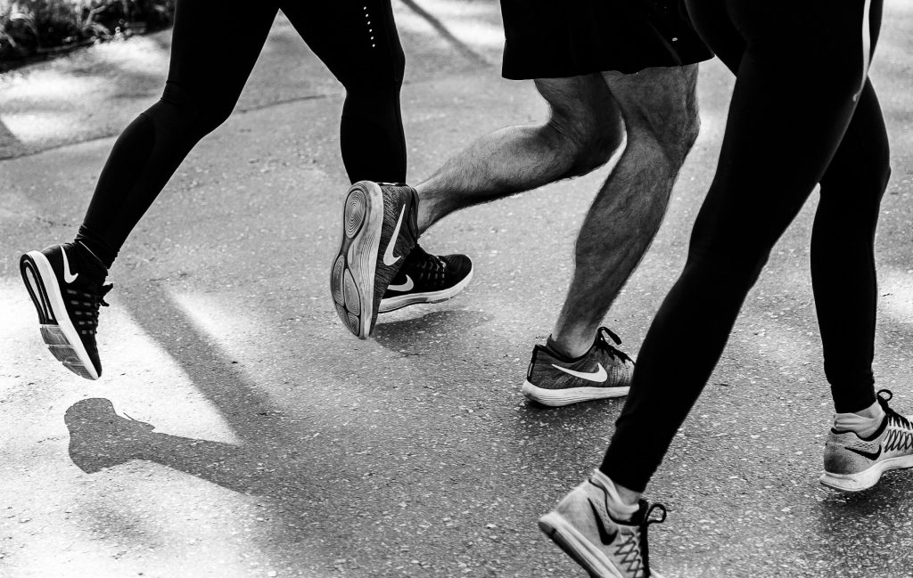 Legs in shorts and running tights striding/running together