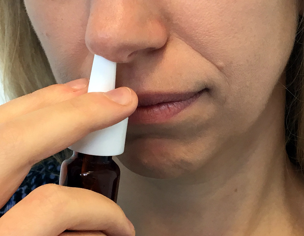 "Nasal Spray" by NIAID is licensed under CC BY 2.0 Photo showing woman using nasal spray.