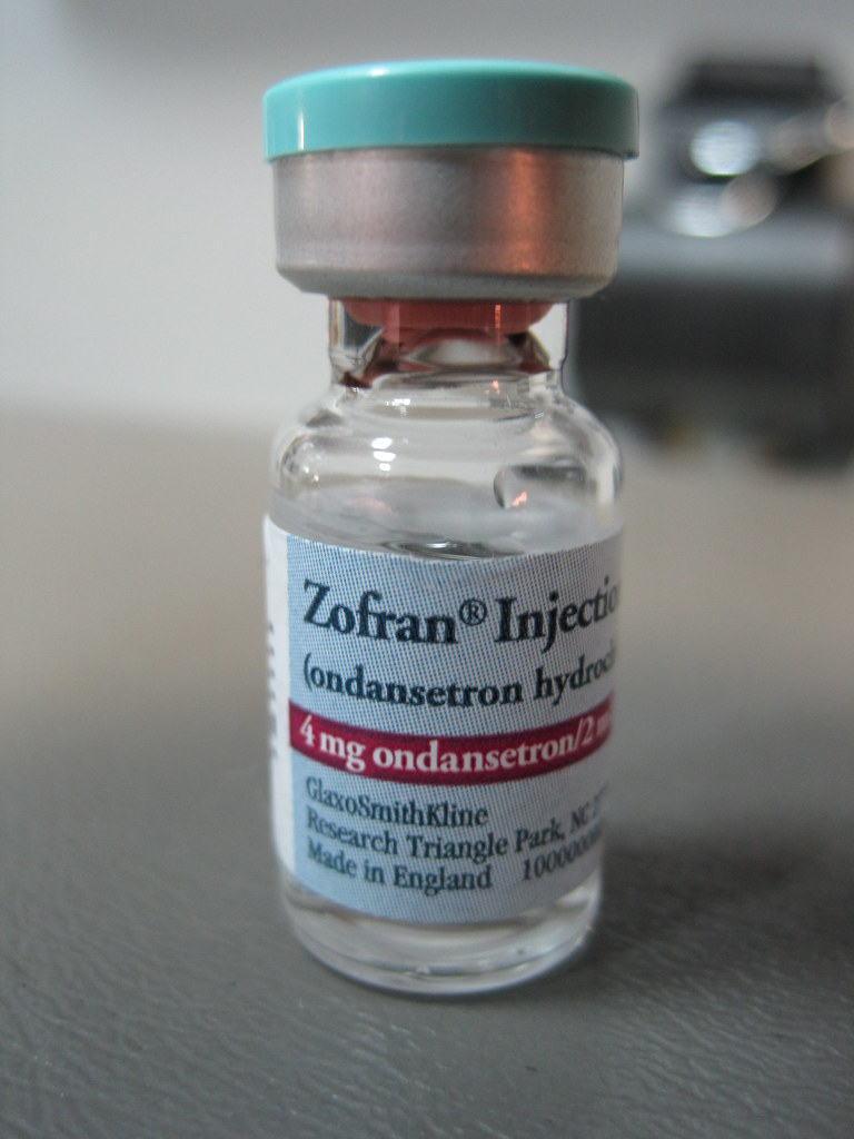 "Ondansetron (1)" by M is licensed under CC BY-NC 2.0 Photo of bottle of Zofran injectable.