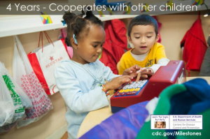 photo of two four year old children, a boy and a girl in cooperative play