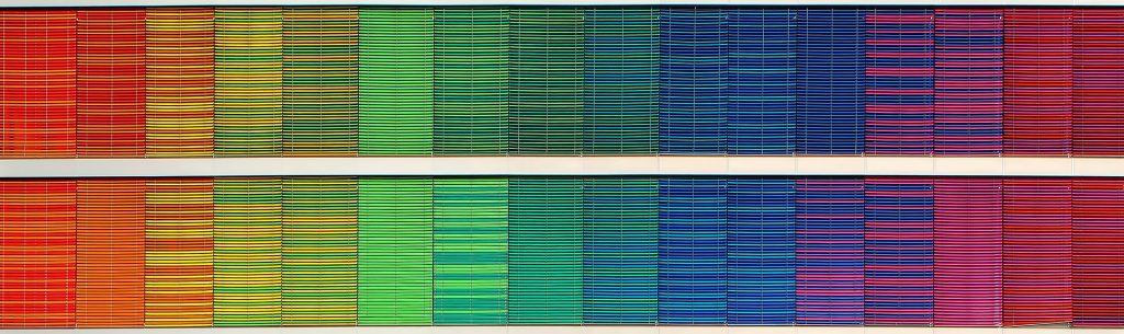 Rainbow, textured facade, mimicking the appearance of cloth books on a shelf