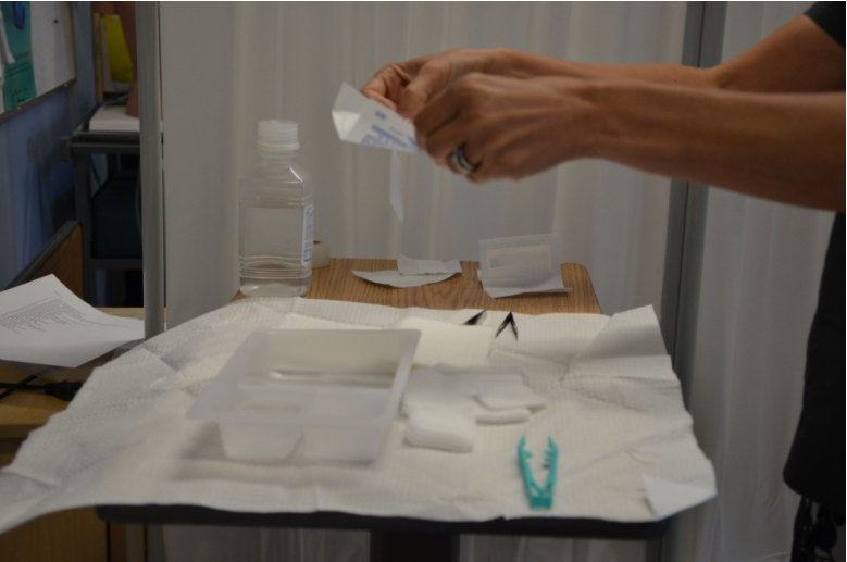 “DSC_0319-1024x678.jpg” by British Columbia Institute of Technology (BCIT) is licensed under CC BY 4.0. Access for free at https://opentextbc.ca/clinicalskills/chapter/sterile-gloving/ Photo of hands dispensing items on a sterile field