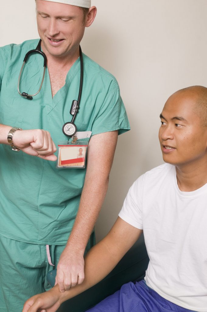 “13394660711603.jpg” by CDC/ Amanda Mills is licensed under CC0 Image showing nurse checking simulated patient's pulse