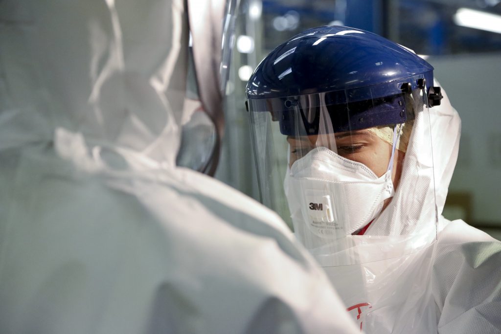 “Checking Personal Protective Equipment (PPE) in the fight against Ebola” by DFID - UK Department for International Development is licensed under CC BY 2.0 Photo showing person in full PPE facing camera