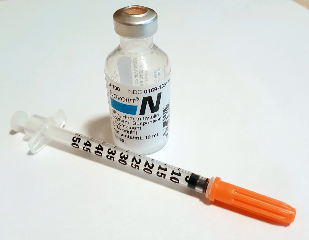 “insulin-syringe” by biologycorner is licensed under CC BY-NC 2.0 Photo showing closeup of a vial of N P H insulin and a capped syringe