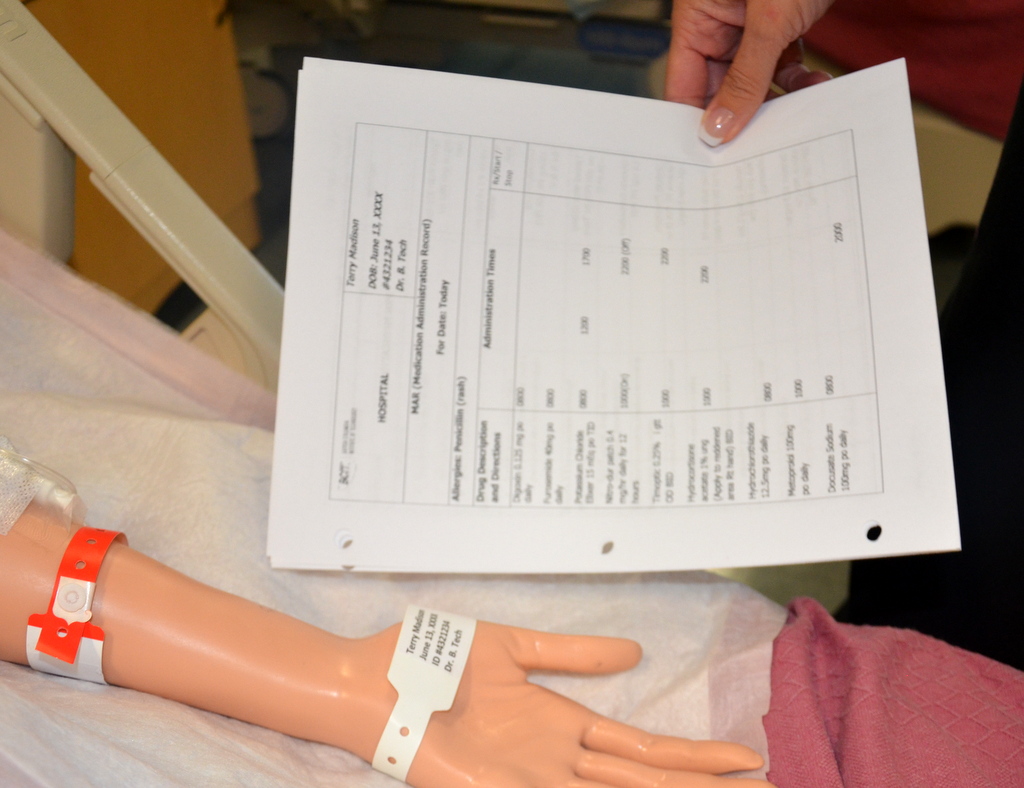 “Book-pictures-2015-430-150x150.jpg” by British Columbia Institute of Technology (BCIT) is licensed under CC BY 4.0.. Access for free at https://opentextbc.ca/clinicalskills/chapter/6-1-safe-medication-adminstration/. Photo of nurse Identifying simulated Patient Prior to Medication Administration