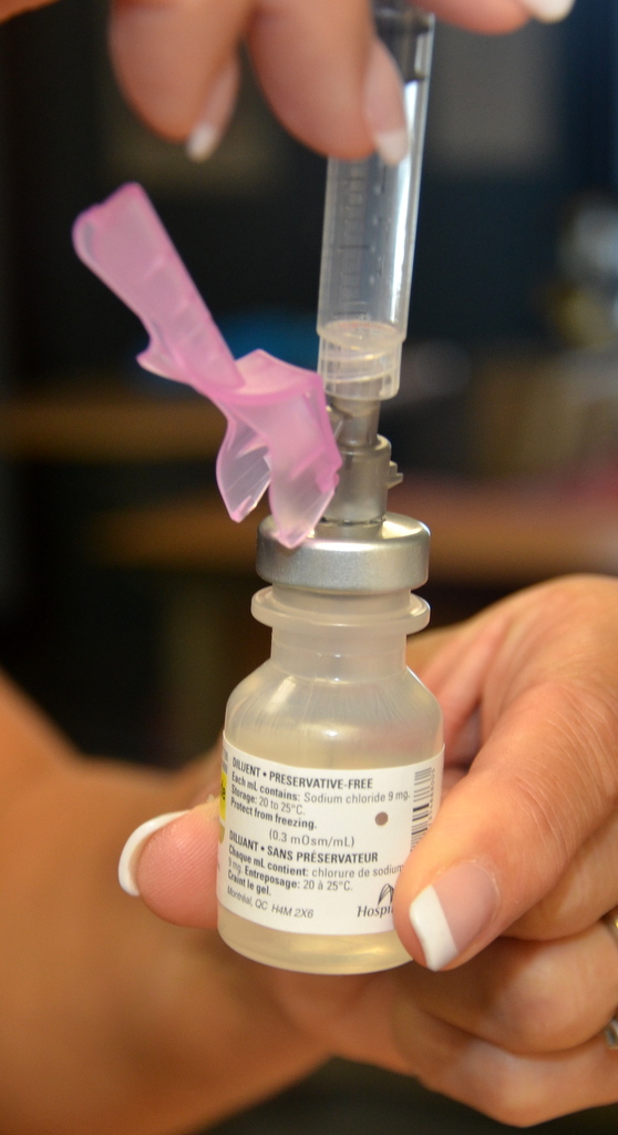 “Book-pictures-2015-527.jpg” by British Columbia Institute of Technology (BCIT) is licensed under CC BY 4.0. Access for free at https://opentextbc.ca/clinicalskills/chapter/safe-injection-administration-and-preparing-medication-from-ampules-and-vials/ Photo showing closeup of safety shield on needle, in use