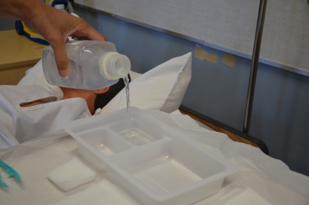 “DSC_0313.jpg” by British Columbia Institute of Technology (BCIT) is licensed under CC BY 4.0. Access for free at https://opentextbc.ca/clinicalskills/chapter/sterile-gloving/ Photo of sterile solution being poured
