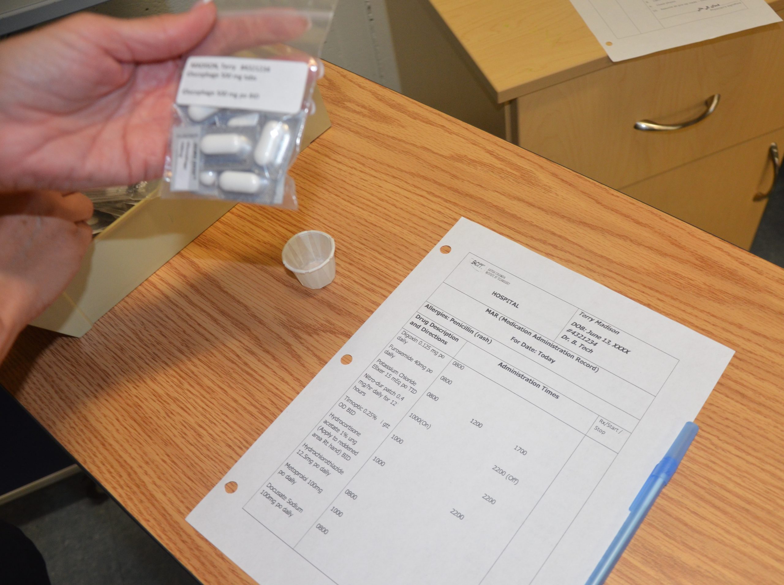 “DSC_17601-150x150.jpg” by by by British Columbia Institute of Technology (BCIT) is licensed under CC BY 4.0. Access for free at https://opentextbc.ca/clinicalskills/chapter/6-1-safe-medication-adminstration/. Photo showing a nurse checking information on pill bag matches what is on MAR