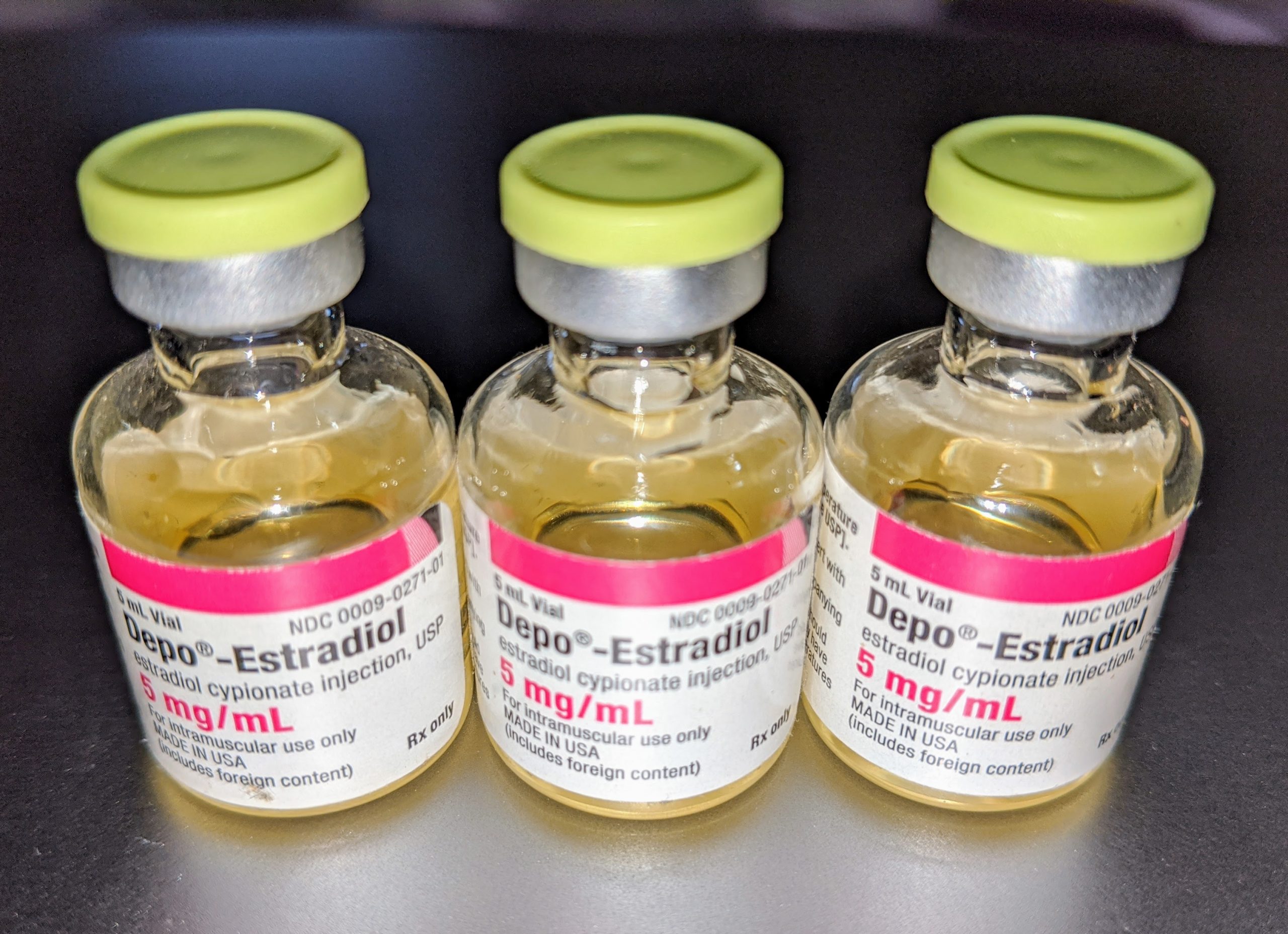 “Depo-Estradiol (estradiol cypionate) vials.jpg” by Medgirl131 is licensed under CC BY-SA 4.0 Photo showing closeup of three vials of Depo-Estradiol, with rubber tops