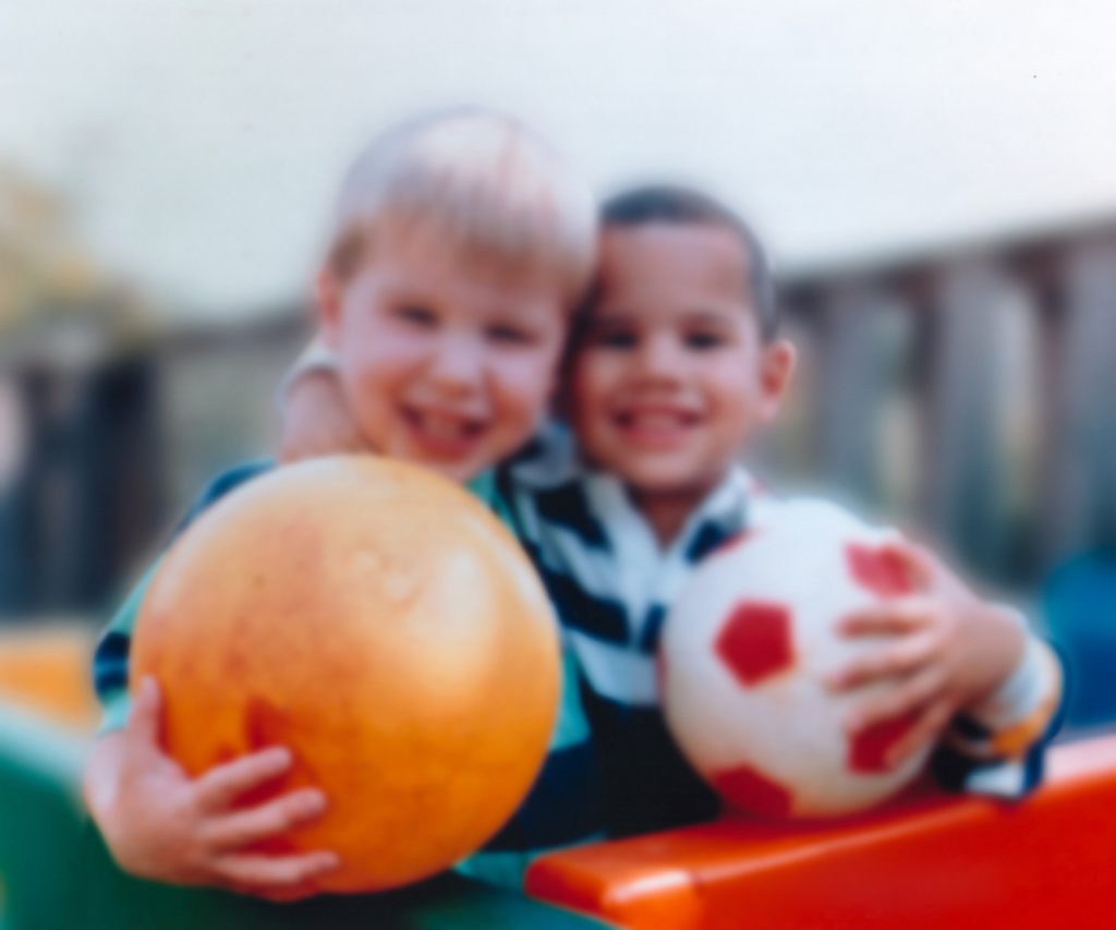 “Eye disease simulation, myopia.jpg” by National Eye Institute, National Institutes of Health is in the Public Domain Photo showing two children, out of focus, to simulate vision with myopia