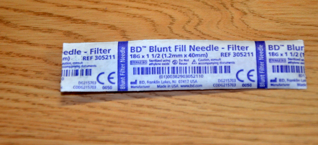 “Oct-2-2015-009.jpg” by British Columbia Institute of Technology (BCIT) is licensed under CC BY 4.0. Access for free at https://opentextbc.ca/clinicalskills/chapter/safe-injection-administration-and-preparing-medication-from-ampules-and-vials/ Photo showing a closeup of a blunt fill needle filter