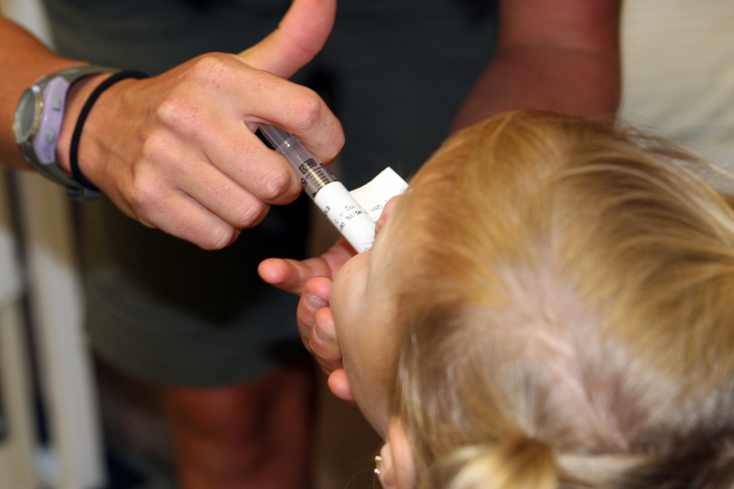 "USMC-080623-M-9467O-024.jpg" by Lance Cpl. Regina A. Ochoa for the United States Marine Corps is in the Public Domain Photo of nurse administering oral medication with a syringe to a child