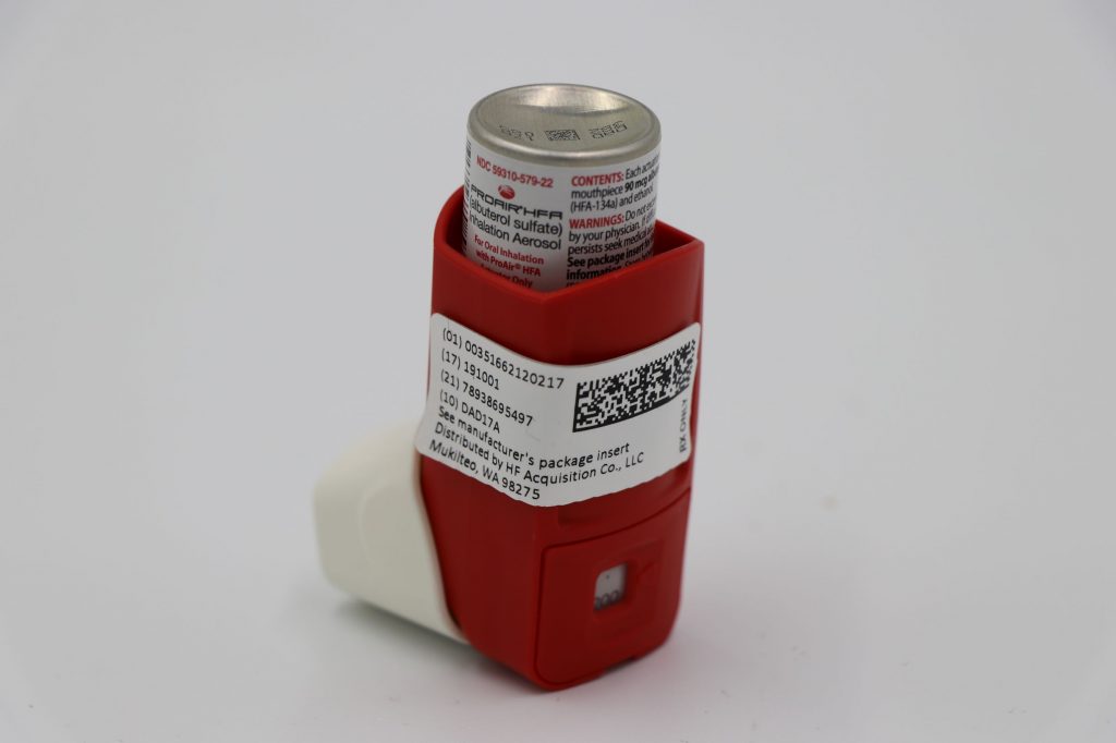 This work is a derivative of “RESIZED+SERIALIZED+1202-1.jpg” courtesy of the U.S.National Library of Medicine. This image is included on the basis of Fair Use. Photo showing albuterol metered dose inhaler