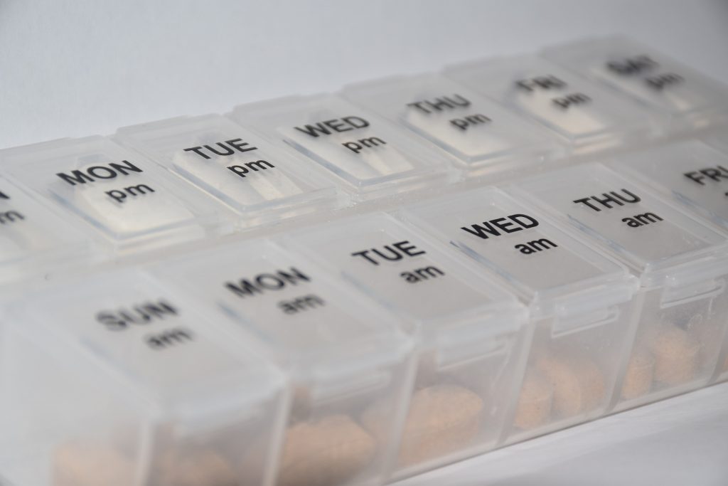 “pills-4005382_960_720.jpg” by Nemo73 is licensed under CC0 Photo showing a medication box, with labels for days of the week