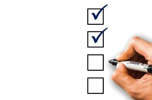 person marking off items on a checklist