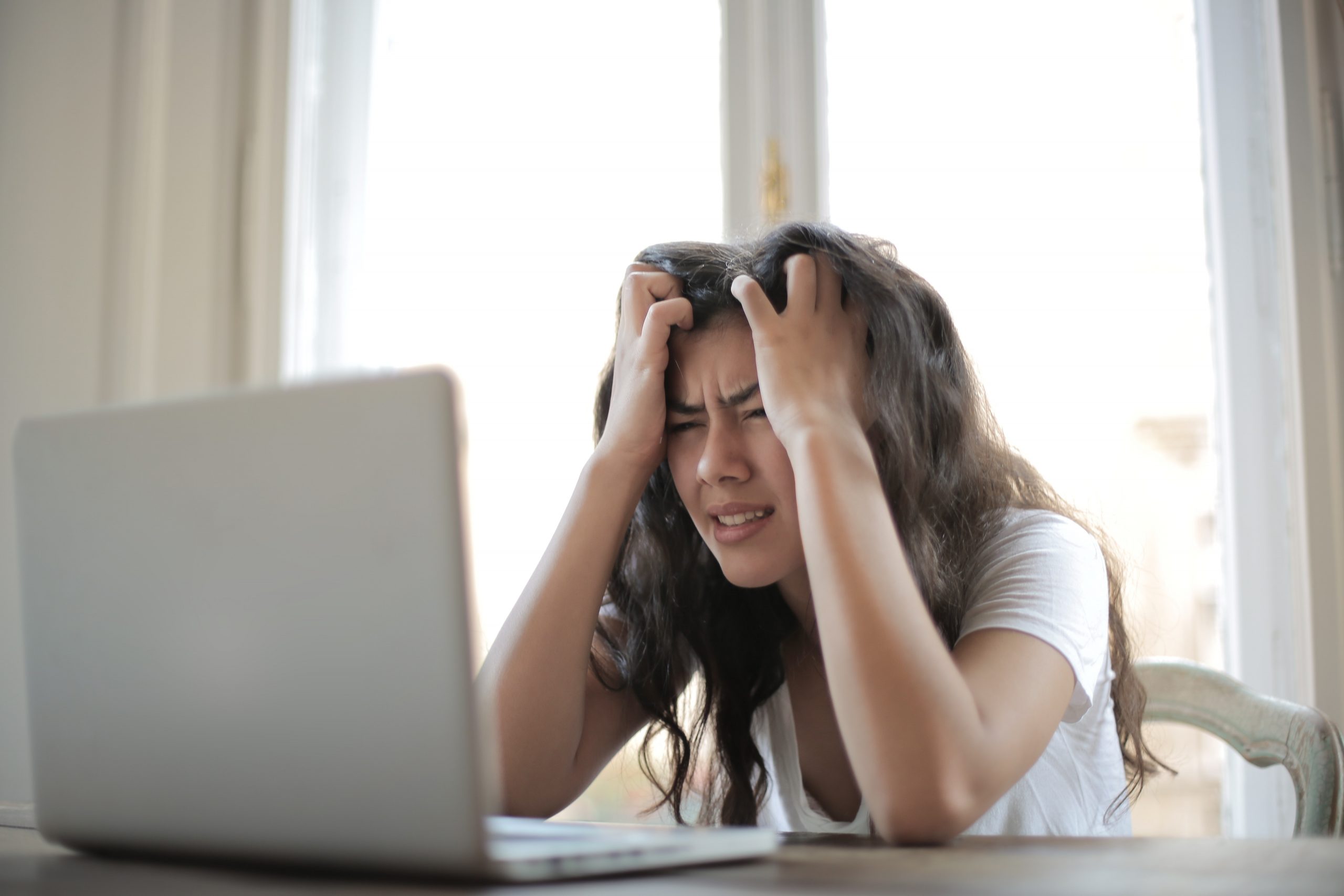 frustrated student working on a laptop