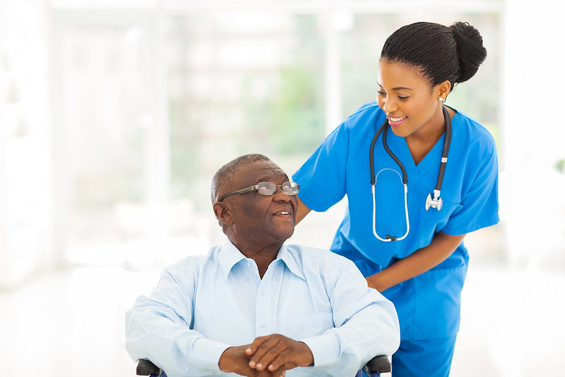 “beautiful african nurse taking care of senior patient in wheelchair” by agilemktg1 is in the Public Domain American Nurse. (n.d.). Therapeutic communication techniques. Photo showing a simulated student nurse interacting with a seated patient