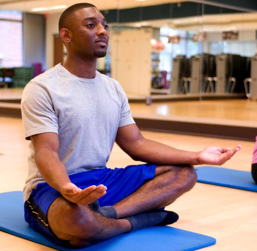 “yoga-class-a-cross-legged-palms-up-meditation-position-850x831.jpg” by Amanda Mills, USCDCP on Pixnio is licensed under CC0 Photo showing a person meditating with eyes open and palms up, while sitting cross legged