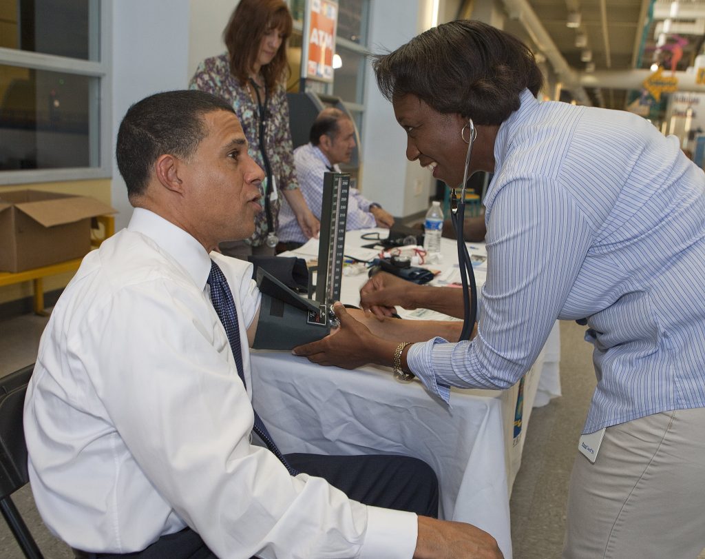 ”7315182496_0cd3e18ed6_k” by Maryland GovPics is licensed under CC BY 2.0 Photo showing medical personnel checking a person's blood pressure