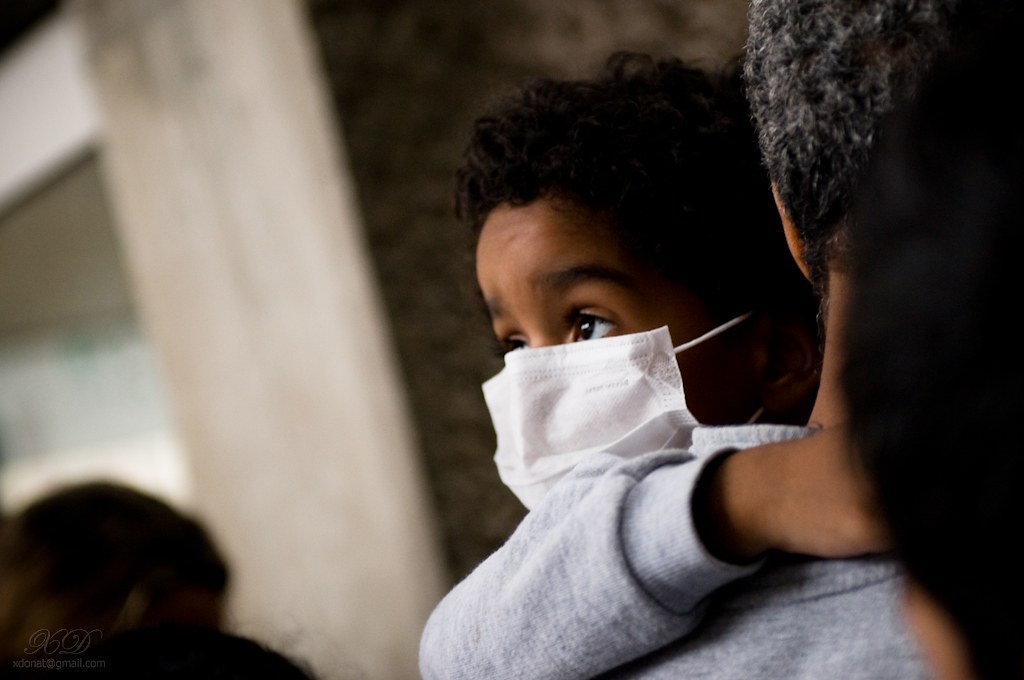 ”3678466365_da63d01385_b” by Xavier Donat is licensed under CC BY-NC-ND 2.0 Photo showing a masked child looking off to side