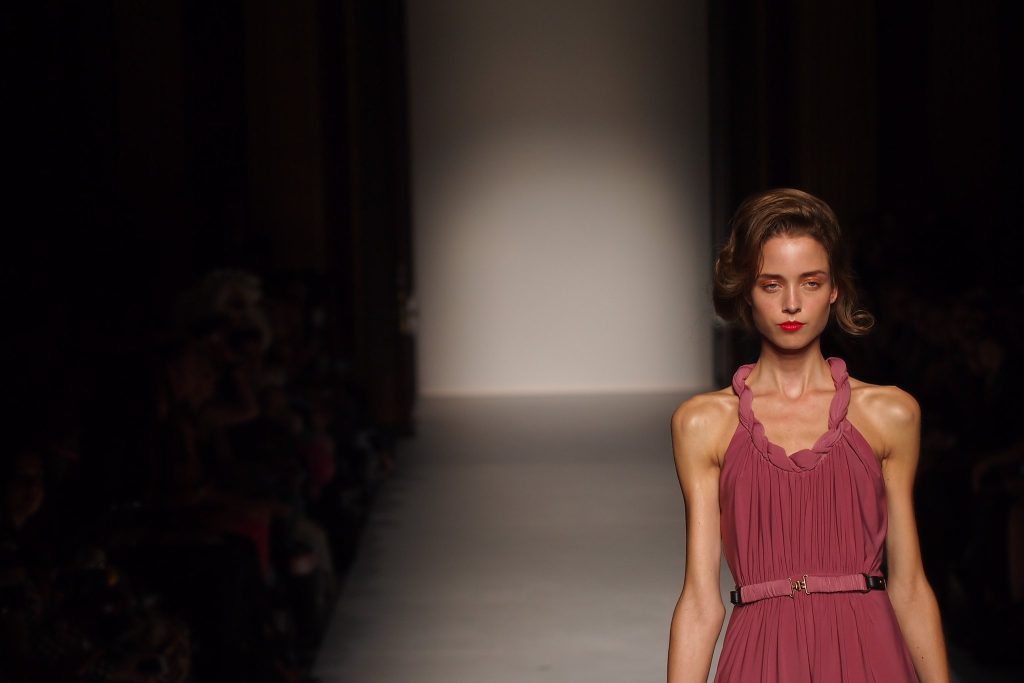 “7991065935_8f05b38f46_k” by Farrukh is licensed under CC BY-NC 2.0. Photo showing a very thin model on a catwalk