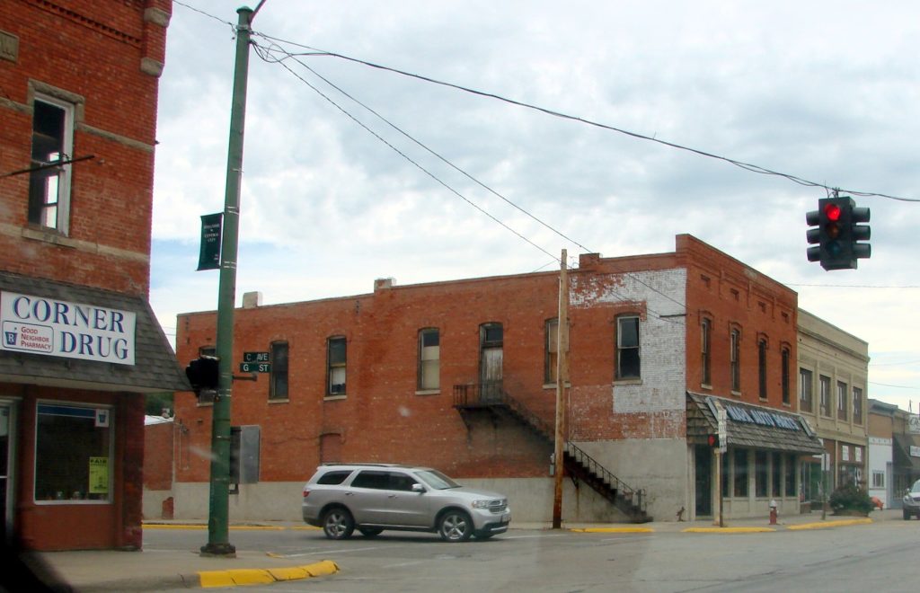 "One_Light_Town"_Small_Town,_Nebraska_7-25-13a_(10784126756).jpg" by inkknife_2000 (7.5 million views +) is licensed under CC BY-SA 2.0 Photo showing downtown in a small town in rural America