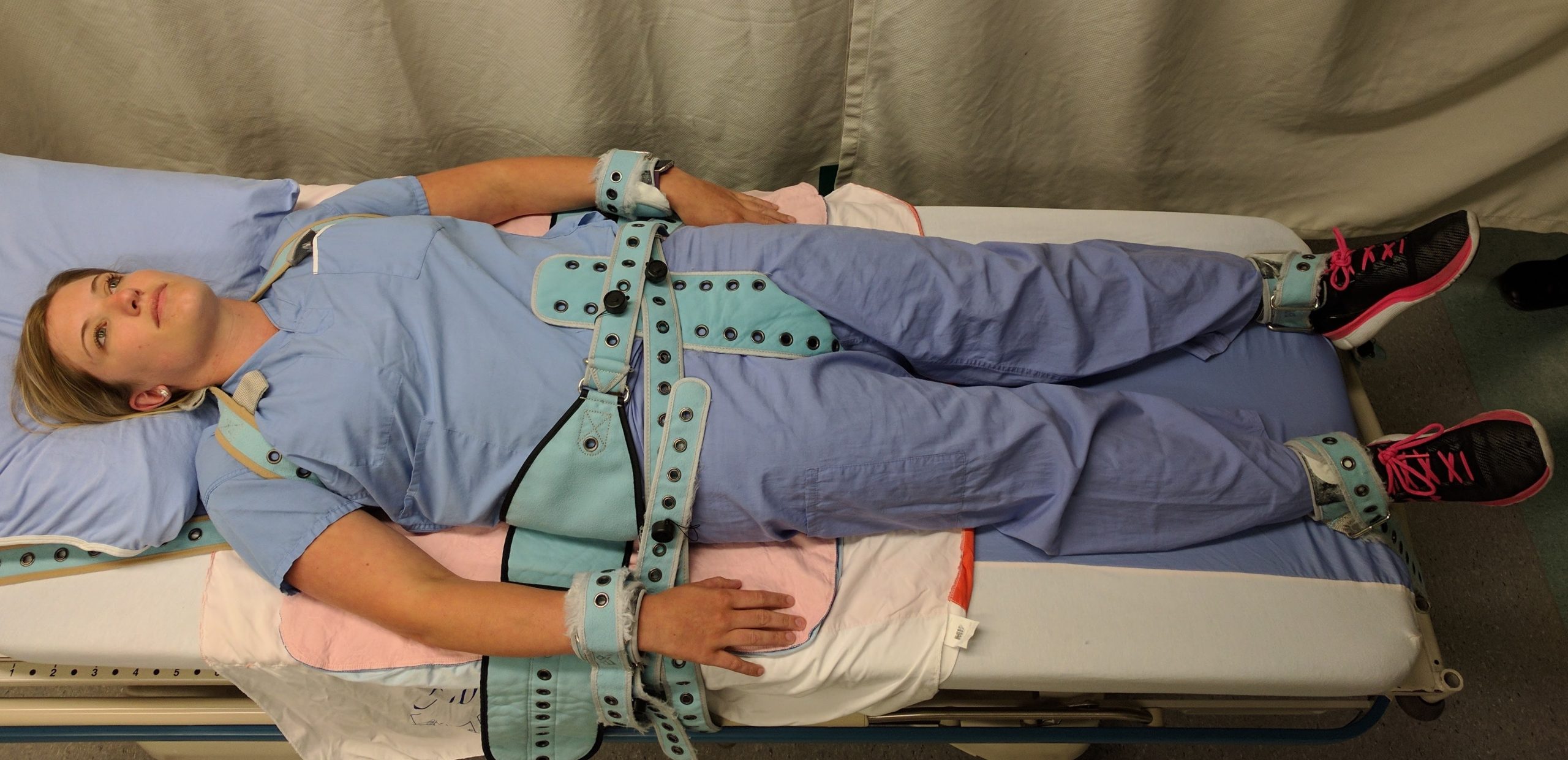 “PinelRestaint.jpg” by James Heilman, MD is licensed under CC BY-SA 4.0 Photo showing a simulated patient in Full Physical Medical Restraints