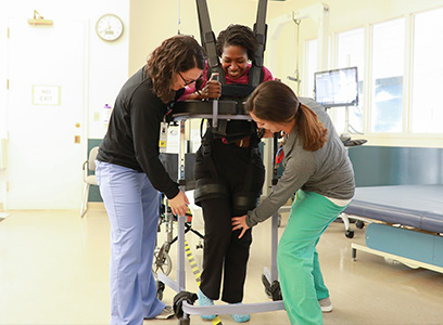 ”tech_zerog.jpg” by unknown author at Gaylord.org is included on the basis of Fair Use Photo showing two therapists providing rehabilitation to a patient in a harness