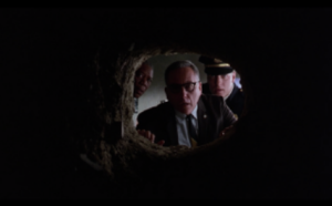 Jailers looking down the tunnel Andy has just escaped through