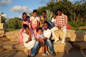 A family sitting on rocks for a picture.